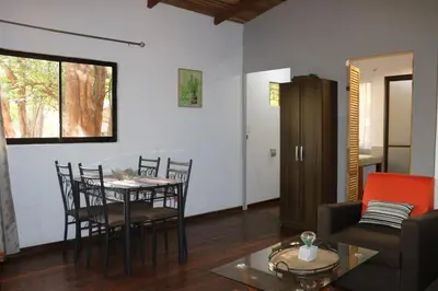 a living room with a table and chairs at CASA NATURaL in Brasilito