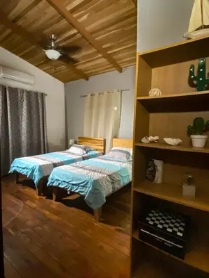 two beds in a room with wooden floors at CASA NATURaL in Brasilito