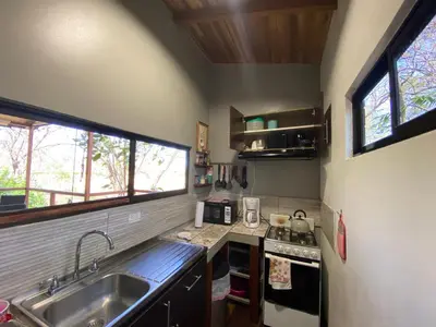 a small kitchen with a sink and a stove at CASA NATURaL in Brasilito