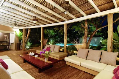 a living room with white couches and a aquarium at Villa Don Vito in Tamarindo