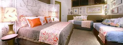 a bedroom with two beds with orange pillows at Villa Don Vito in Tamarindo
