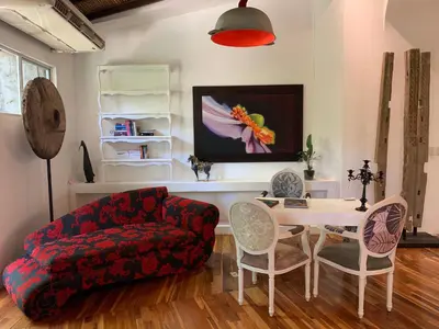 a living room with a couch and a table and chairs at Villa Don Vito in Tamarindo