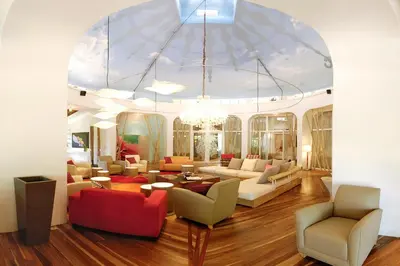 a living room with couches and chairs and a chandelier at Villa Don Vito in Tamarindo