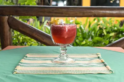 a drink in a glass sitting on a table at Diuwak in Dominical