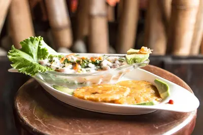 a plate of food with a salad on a table at Diuwak in Dominical