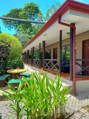a guest house with a patio and a table at Diuwak in Dominical