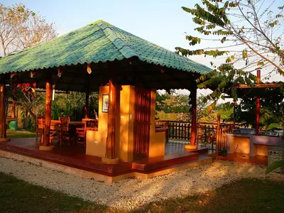 a pavilion with a table and chairs in a park at Fidelito Ranch & Lodge in Tambor