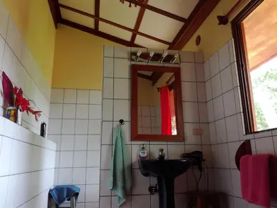 a bathroom with a sink and a mirror at Fidelito Ranch & Lodge in Tambor