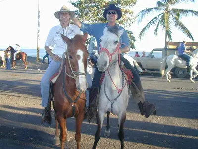 two people riding on horses on the beach at Fidelito Ranch & Lodge in Tambor