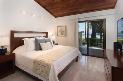 a bedroom with a bed and a large window at Casa Woodbine Private House on Tamarindo Beach in Tamarindo