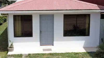 a white tiny house with a red roof at HOUSE CATTLEYA monteverde in Monteverde Costa Rica