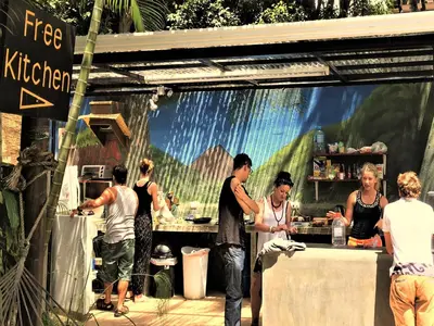 a group of people standing around a food stand at Costa Rica Backpackers in San José