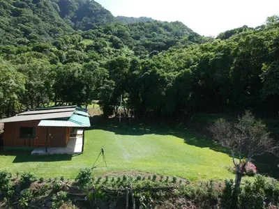 a small building on a grassy field in a forest at Casitas de Montaña Cabuya in Monteverde Costa Rica