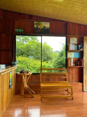 a room with a bench and a large window at Casitas de Montaña Cabuya in Monteverde Costa Rica