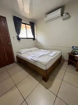 a bedroom with a bed in a room with a window at Le Petit Hotel in Fortuna