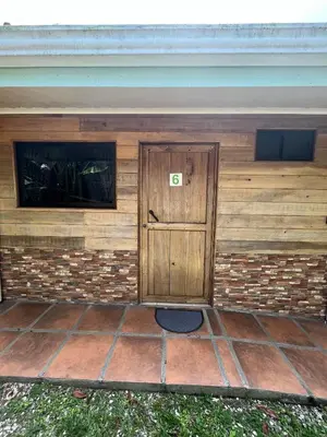 a building with a wooden door with the number six at Le Petit Hotel in Fortuna