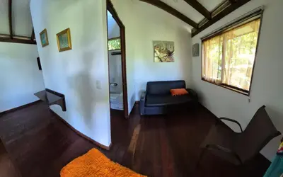 a living room with a couch and a window at Centro Ananda, Cabina, Bambuszelt in Guápiles
