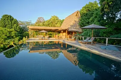 a villa with a swimming pool and a resort at Calamocha Lodge in Santa Teresa Beach
