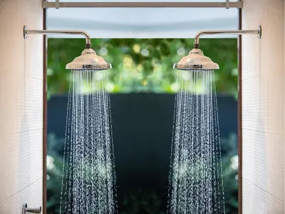 two shower heads with water coming out of them at Pumilio Mountain & Ocean Hotel in Jacó