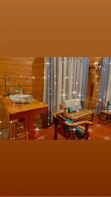 a room with a table and a chair and a sink at Clusia Lodge in El Copey