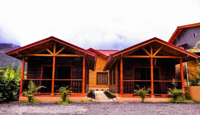 a log cabin with two large windows at Clusia Lodge in El Copey