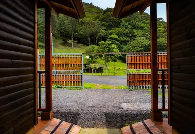 an open door to a gate with a view at Clusia Lodge in El Copey