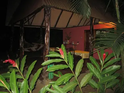 a room with green plants and a tent at Hotel El Paraiso Escondido - Costa Rica in Jacó