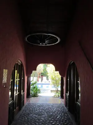 an empty hallway with a ceiling fan in a building at Hotel El Paraiso Escondido - Costa Rica in Jacó