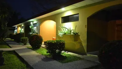 a house with plants on the side of it at night at Villa Creole in Jacó