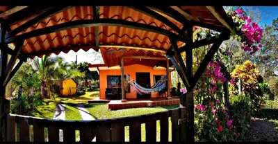 a wooden gazebo in front of a house at casa de playa Paraíso terrenal in San Juanillo