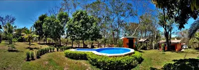 a swimming pool in the middle of a yard at casa de playa Paraíso terrenal in San Juanillo