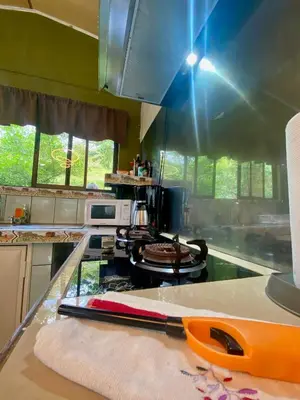 a kitchen with a counter with an orange knife on it at Ferreto`s House in El Castillo de La Fortuna