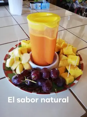 a plate of fruit and a glass of orange juice at Casa Ital-Tico, Playa Negra in Playa Negra
