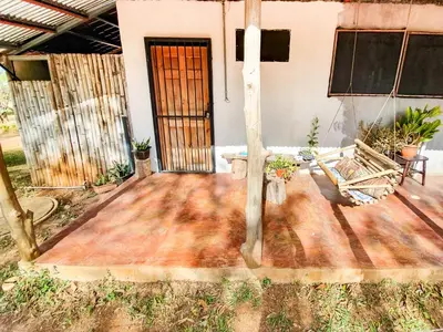 a house with a wooden floor and a door at Casa Ital-Tico, Playa Negra in Playa Negra