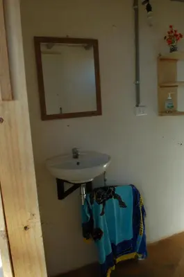 a bathroom with a sink and a mirror on the wall at Casa Ital-Tico, Playa Negra in Playa Negra