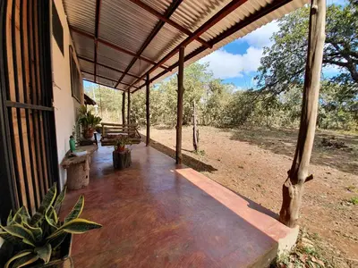 an empty porch of a house with a wooden roof at Casa Ital-Tico, Playa Negra in Playa Negra