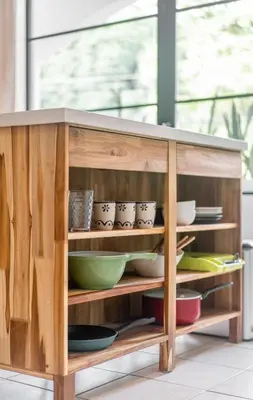 a wooden cabinet filled with bowls and dishes at Plaza Royal Apartments in Santa Teresa Beach