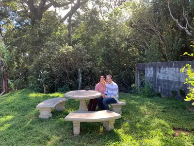 two women sitting at a picnic table in a yard at Globi Lodge #3 in Monteverde Costa Rica