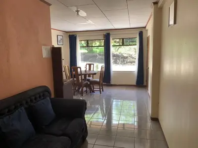 a living room with a couch and a table at Globi Lodge #3 in Monteverde Costa Rica