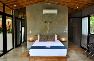 a bedroom with a large bed in a room at Villas Kalei in Playa Grande