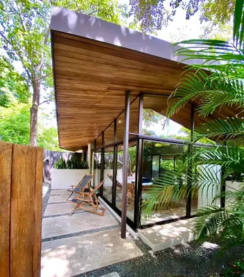 a modern house with a glass facade at Villas Kalei in Playa Grande