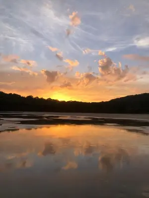 a sunset on a river with the reflection of the sky at Villas Kalei in Playa Grande