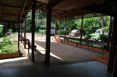 a pavilion with a car parked in a park at La Laguna del Lagarto Eco-Lodge in Pital
