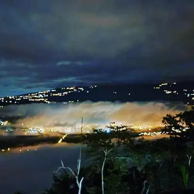 a foggy view of a city at night at Pochotel in Turrialba