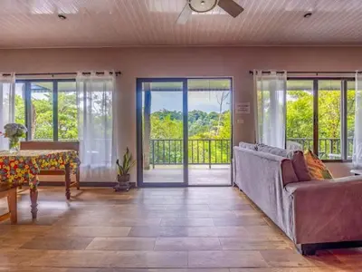 a living room with a couch and a table at Cantos Del Bosque in Monteverde Costa Rica