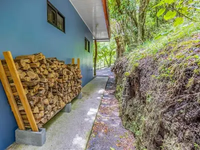 a pile of logs on the side of a building at Cantos Del Bosque in Monteverde Costa Rica