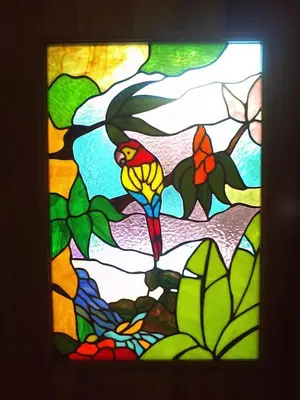 a stained glass window with a bird on a tree at Villa Vista Verde Ground Floor Home, Save Hundreds on your trip, Reduced Prices on Tours in Quepos