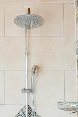 a shower with a shower head in a bathroom at Ficus Sunset Suites in Monteverde Costa Rica