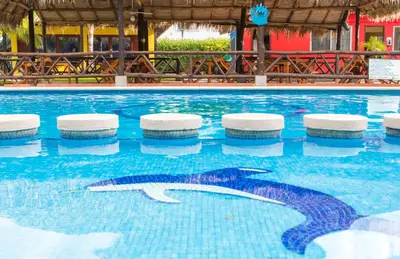 a swimming pool with a shark in the water at Hotel Guanacaste Lodge in Playa Flamingo