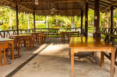 a group of tables and chairs in a pavilion at Hotel Guanacaste Lodge in Playa Flamingo